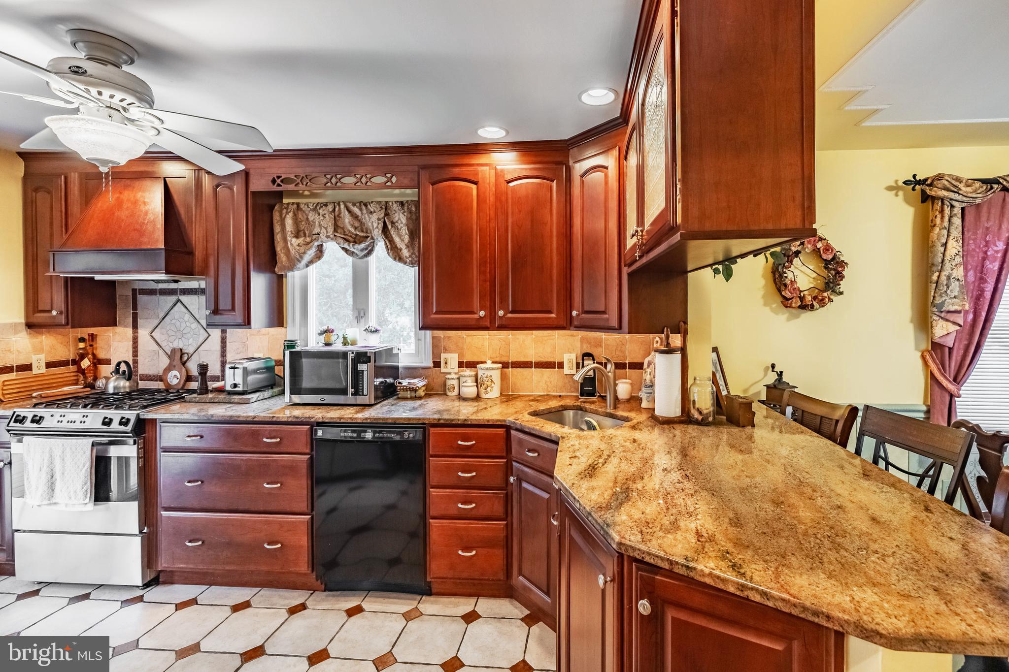 212 Golf Hills Road Havertown, PA 19083 - Photo 10 of 37 a kitchen with a sink stove and cabinets