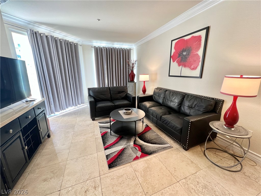 270 East Flamingo Road, Unit 313 Las Vegas, NV 89169 - Photo 4 of 27 Natural light illuminates the elegant crown molding and tiled floors in this inviting living area.