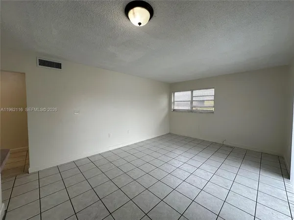 a view of an empty room and window