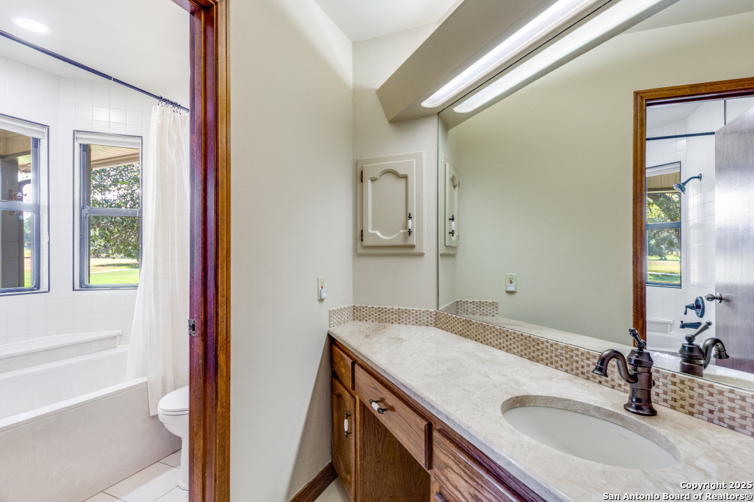122 Cliffdwellers Path Boerne, TX 78006 - Photo 17 of 35 a bathroom with a granite countertop sink and a mirror