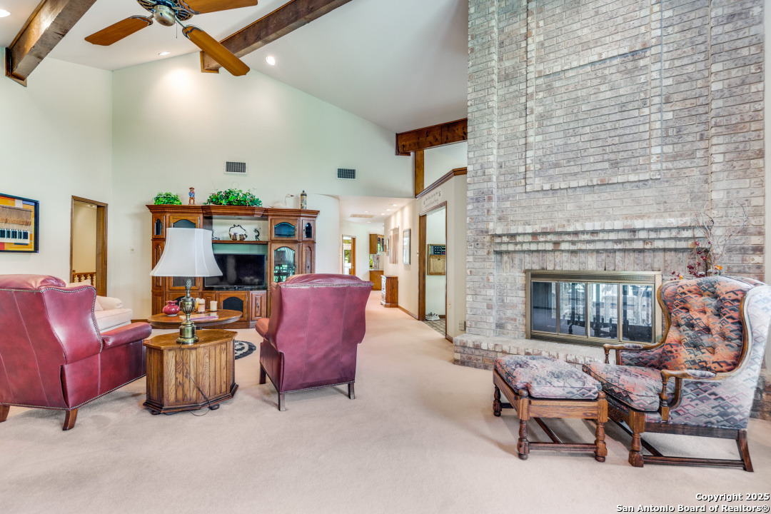 122 Cliffdwellers Path Boerne, TX 78006 - Photo 3 of 35 a living room with furniture and a fireplace