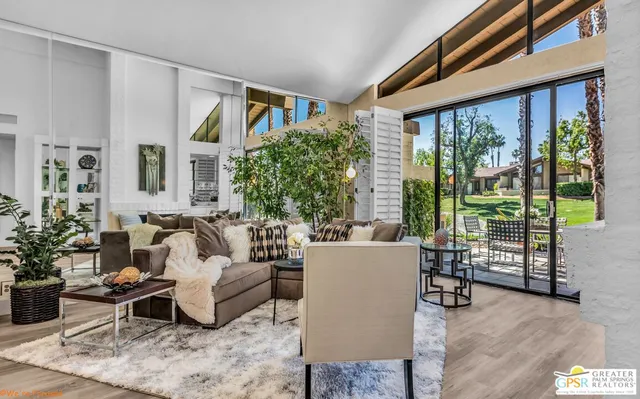 a view of a patio with table and chairs and potted plants