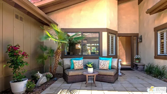 a view of a patio with couches and potted plants
