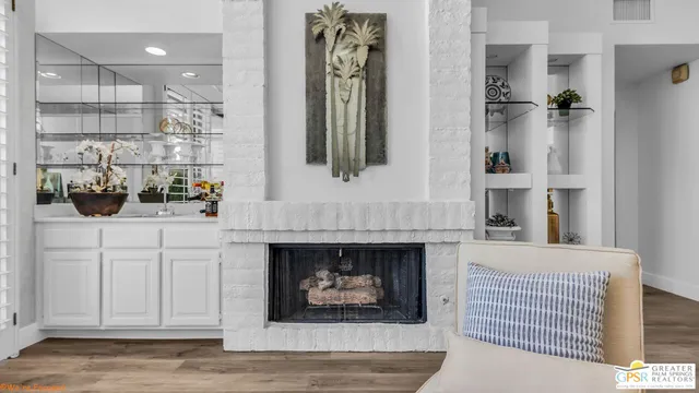 a en suite bathroom with a granite countertop sink and a mirror