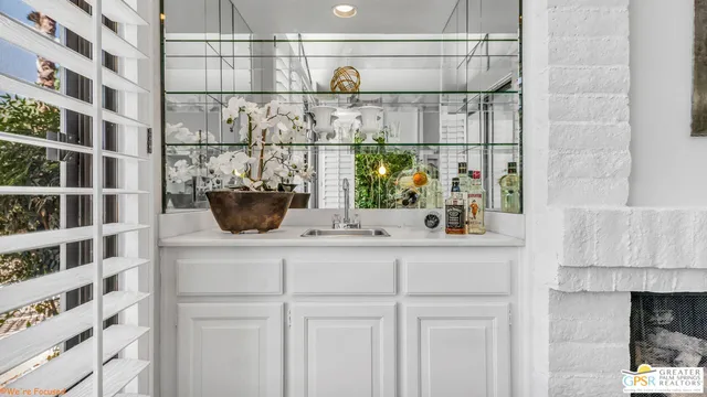 a living room with a sink and a chandelier