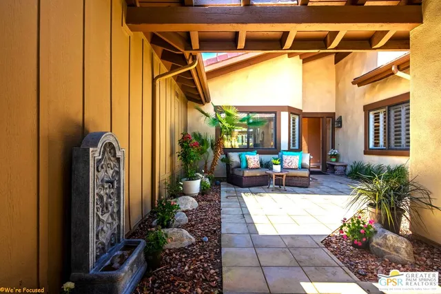 a living room with furniture and a potted plant