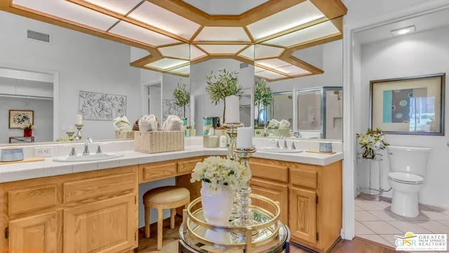 an aerial view of a city with lots of residential buildings and mountain view in back