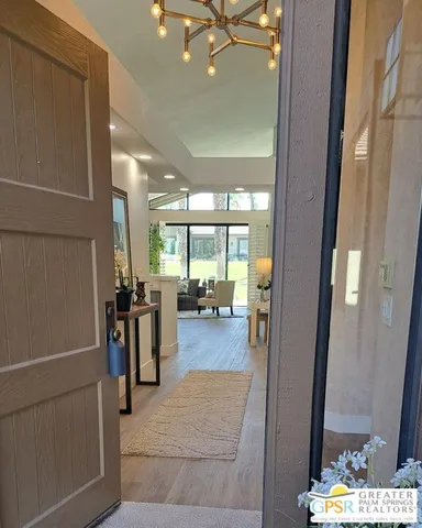 a view of living room with furniture and large windows
