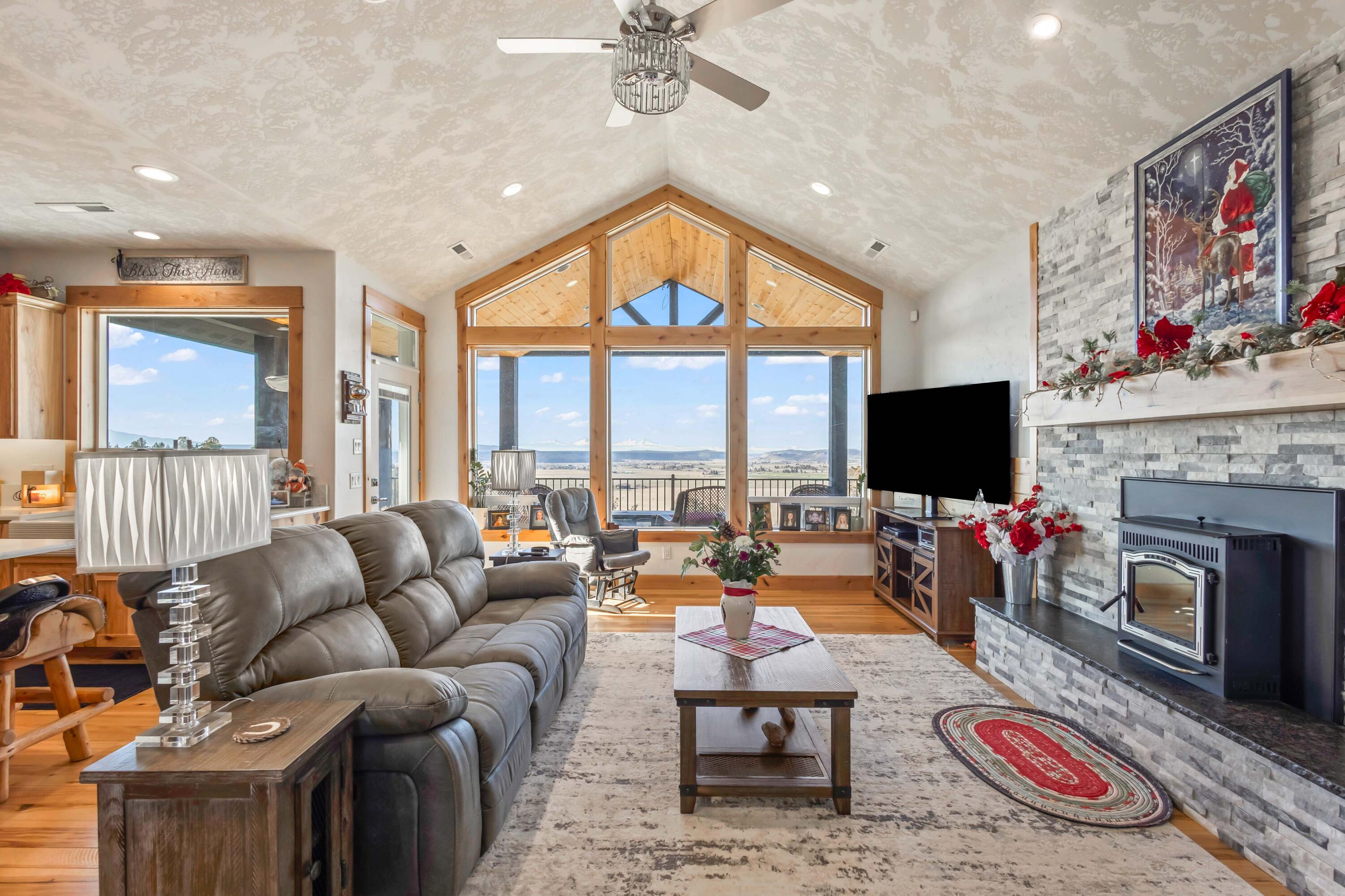 5582 North Mckay Road Prineville, OR 97754 - Photo 8 of 54 a living room with furniture a flat screen tv and a fireplace