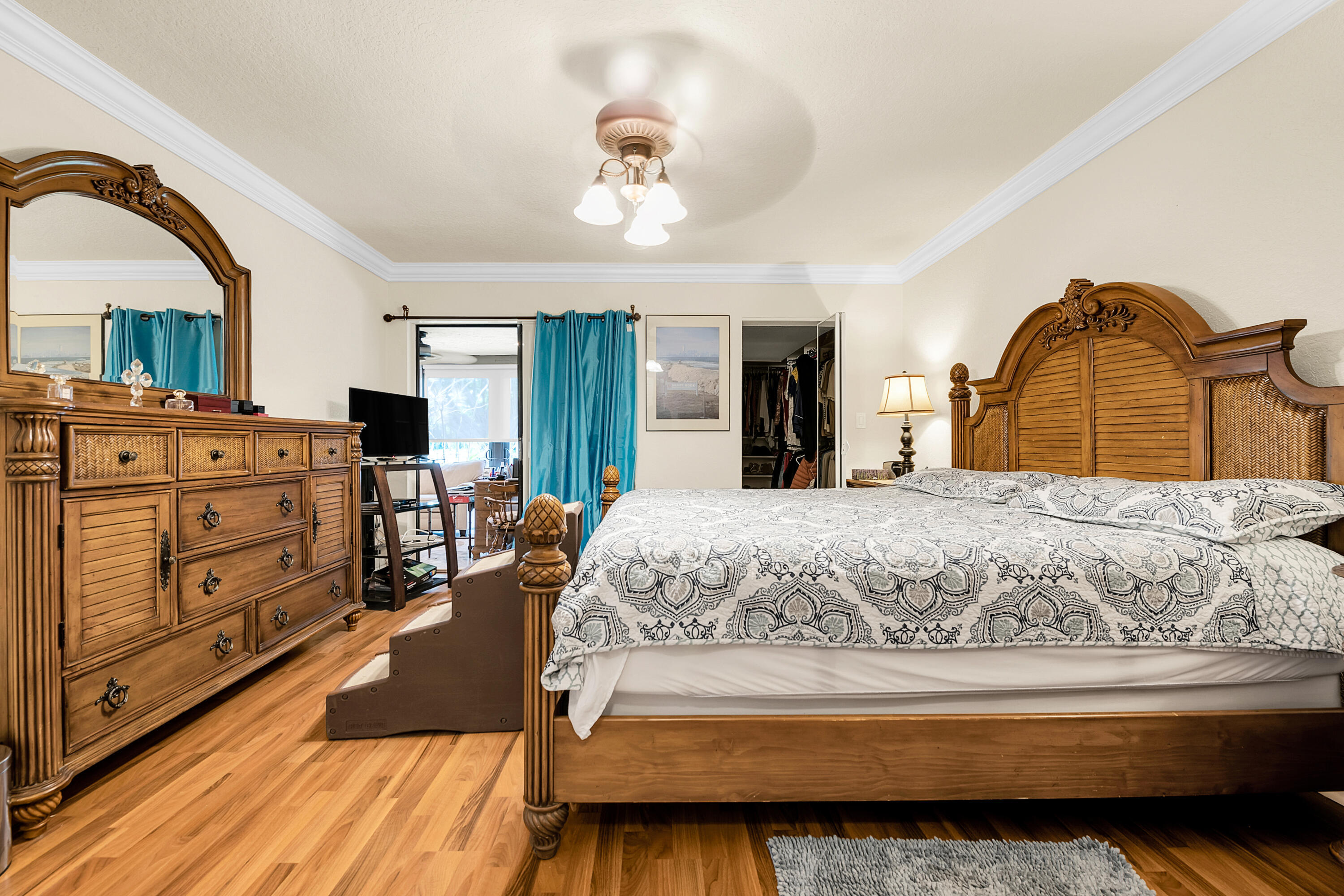 8440 Boca Glades Boulevard East Boca Raton, FL 33434 - Photo 7 of 16 a spacious bedroom with a bed and dresser