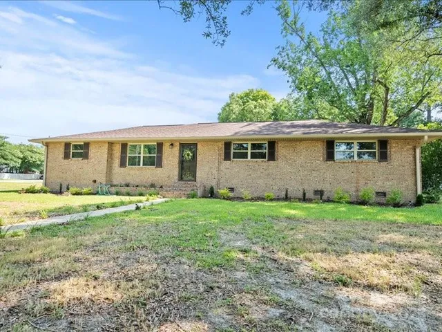 a view of a house with yard and a garden