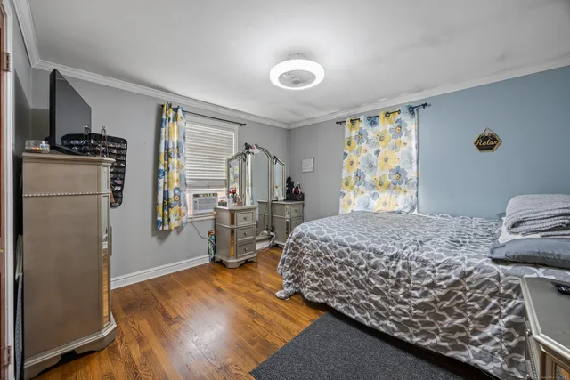 a bedroom with a bed and a refrigerator