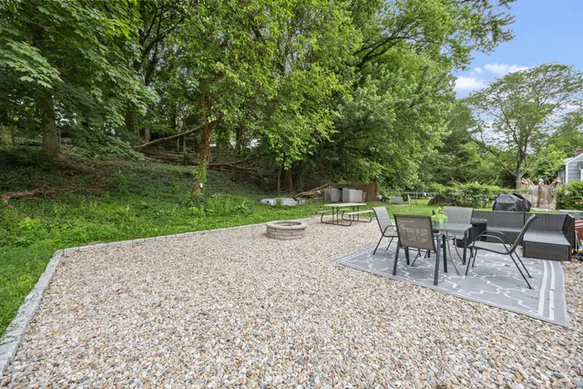 a table and chairs in backyard of the house