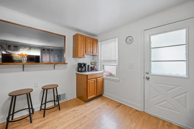 a kitchen with stainless steel appliances granite countertop a stove a sink dishwasher and a refrigerator with wooden floor