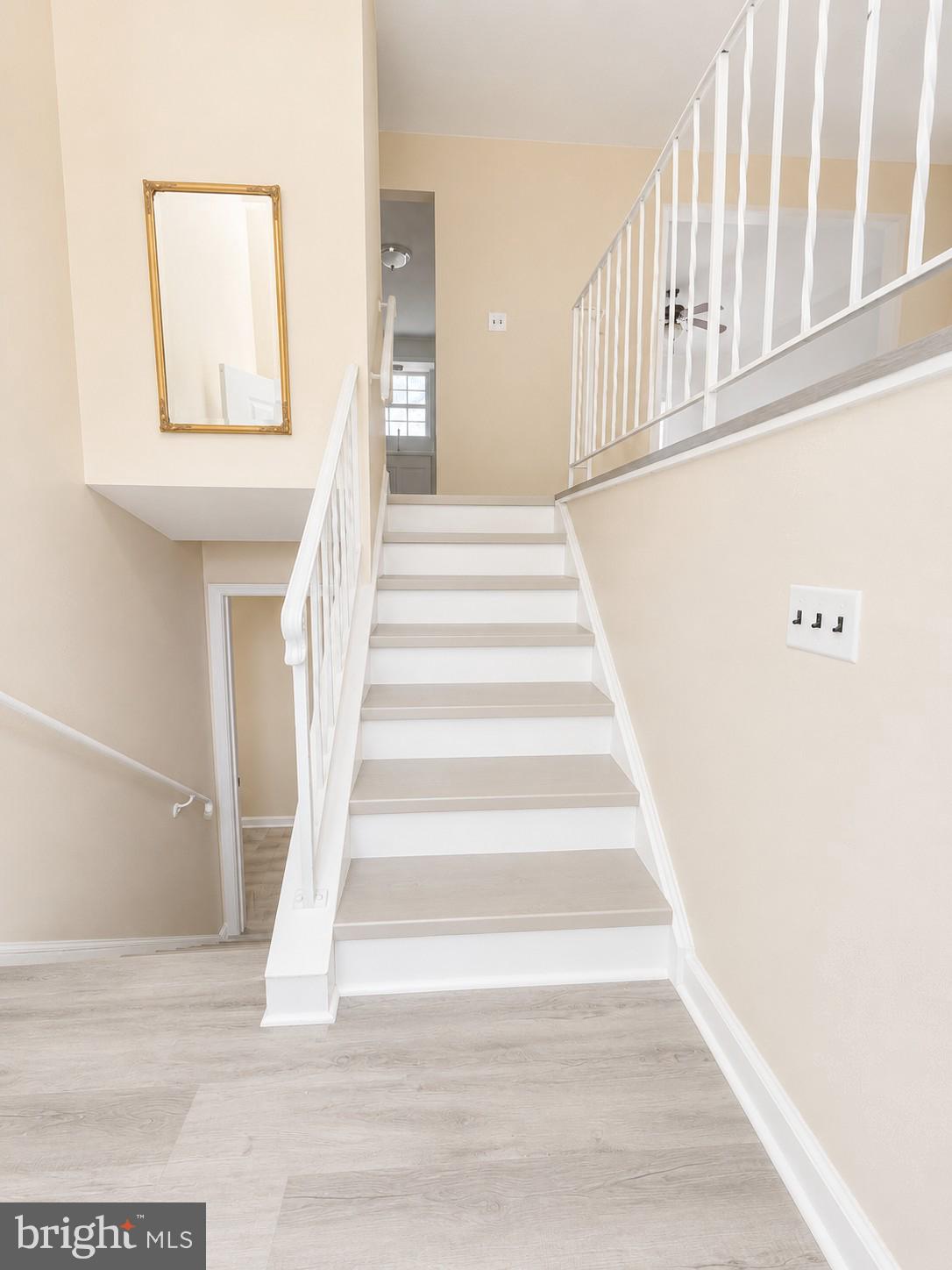 6204 Cipriano Road Lanham, MD 20706 - Photo 2 of 19 a view of staircase with white walls and a window