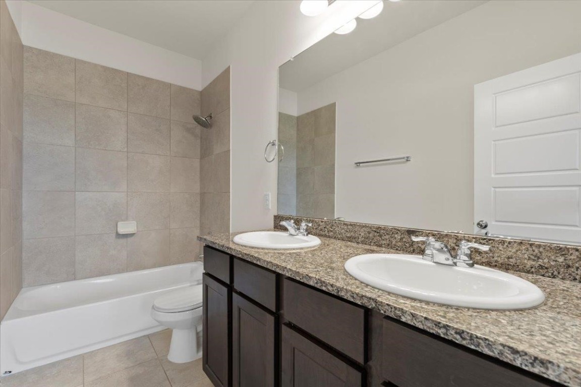 128 Dodge Road Georgetown, TX 78626 - Photo 14 of 18 a bathroom with a granite countertop sink toilet and shower