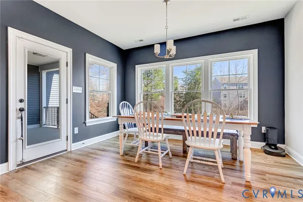 a view of a dining room with furniture wooden floor and chandelier