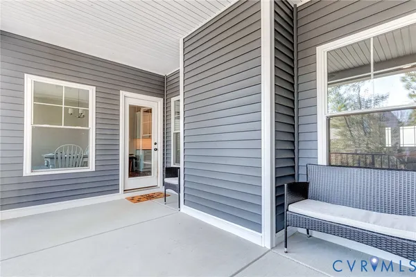 a view of a house with a large window and brick walls