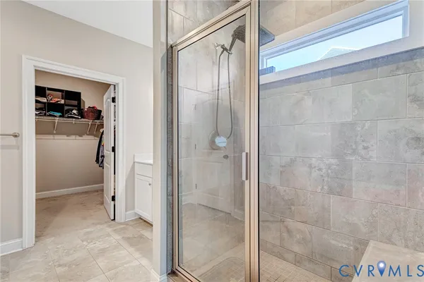 a bathroom with a glass shower door