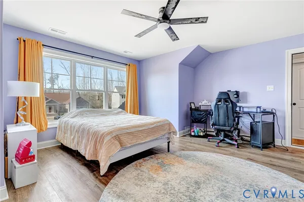 a bedroom with a bed and large windows