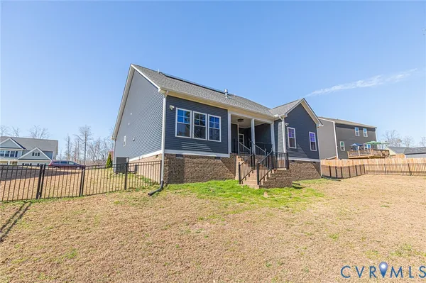 a view of house with a big yard and potted plants