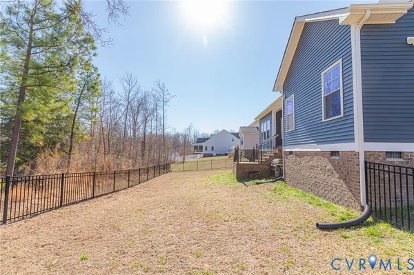 a view of a backyard with a wooden fence