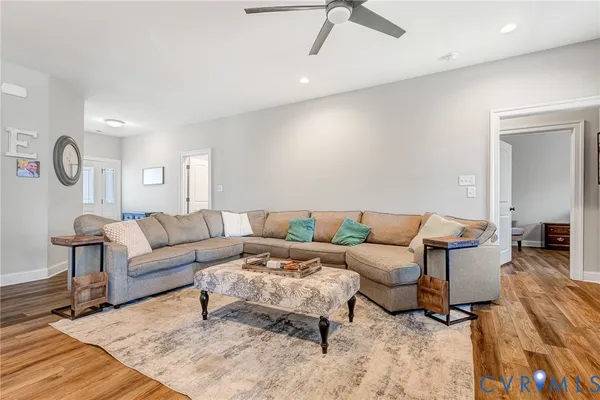 a living room with furniture and a wooden floor
