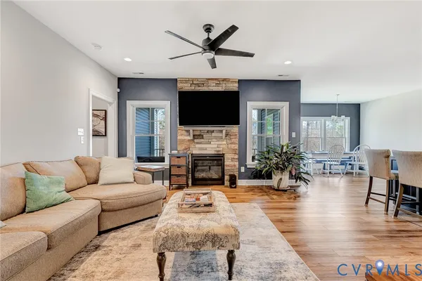 a living room with furniture a fireplace and a flat screen tv