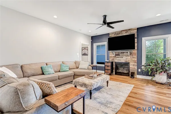 a living room with furniture a fireplace and a flat screen tv