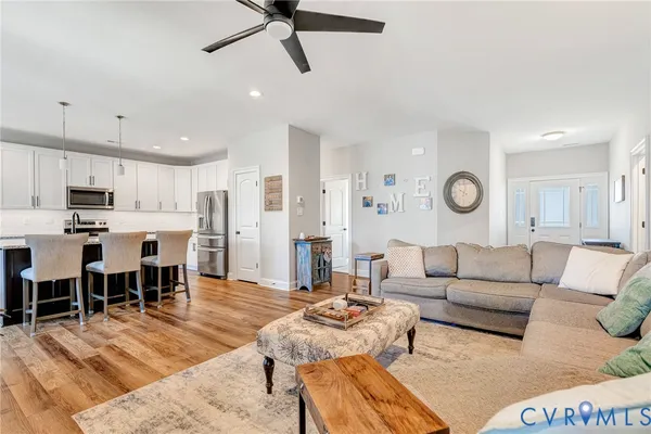 a living room with furniture kitchen view and a dining table
