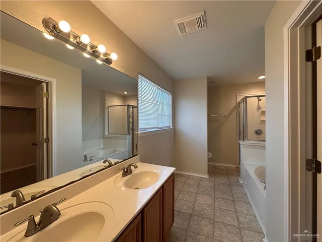 a bathroom with a sink double vanity and a mirror