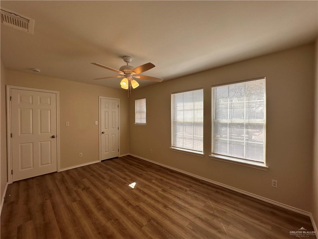 819 Briarwood Drive Mission, TX 78574 - Photo 14 of 19 a view of an empty room with a window and wooden floor