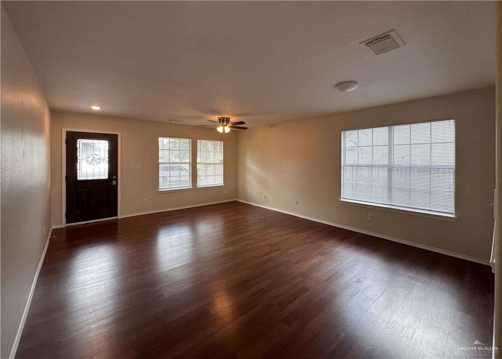 819 Briarwood Drive Mission, TX 78574 - Photo 3 of 19 an empty room with wooden floor and windows