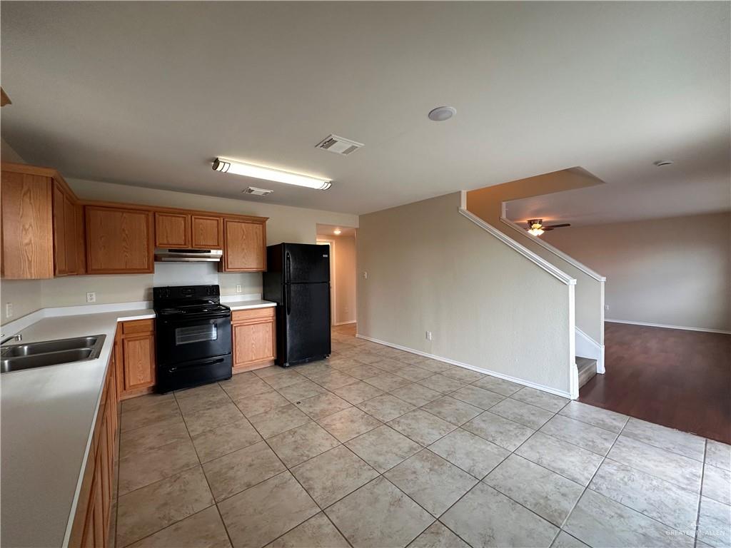 819 Briarwood Drive Mission, TX 78574 - Photo 5 of 19 a kitchen with granite countertop a refrigerator and a stove top oven