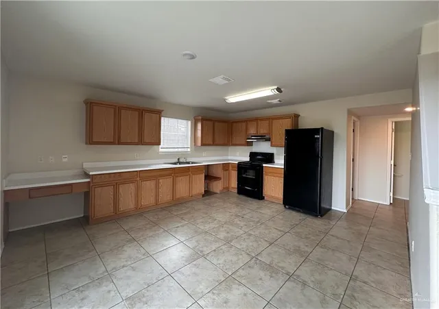 a large kitchen with cabinets and stainless steel appliances