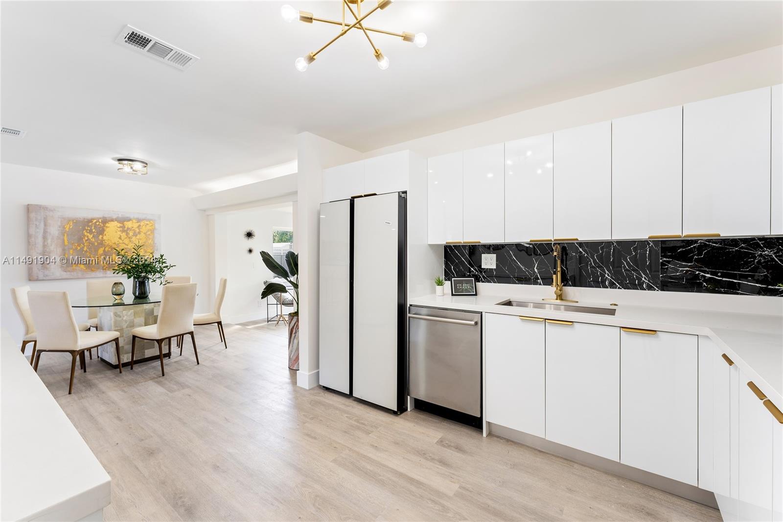 3254 Lincoln Street Hollywood, FL 33021 - Photo 14 of 27 a view of kitchen with stainless steel appliances refrigerator stove microwave and dining table