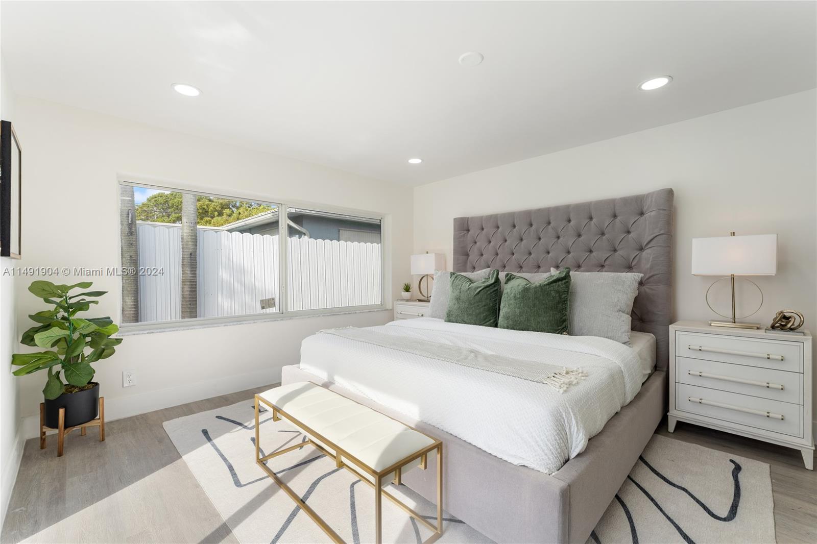 3254 Lincoln Street Hollywood, FL 33021 - Photo 18 of 27 a bedroom with a bed and a potted plant