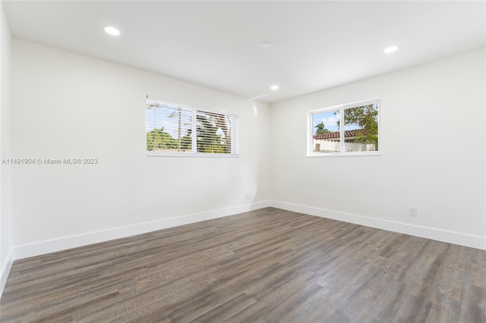 3254 Lincoln Street Hollywood, FL 33021 - Photo 21 of 27 an empty room with wooden floor and windows