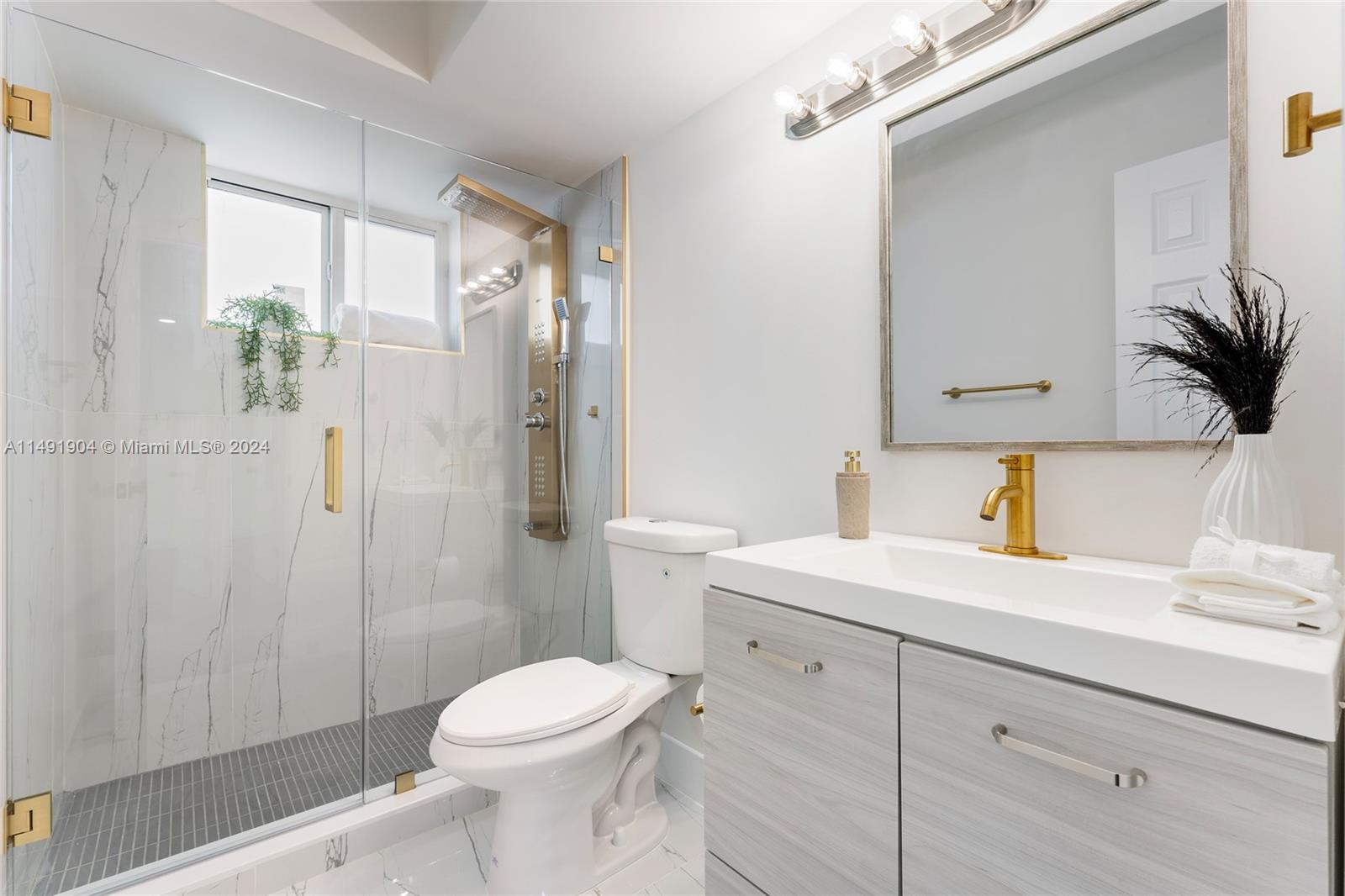 3254 Lincoln Street Hollywood, FL 33021 - Photo 23 of 27 a bathroom with a sink a toilet and shower