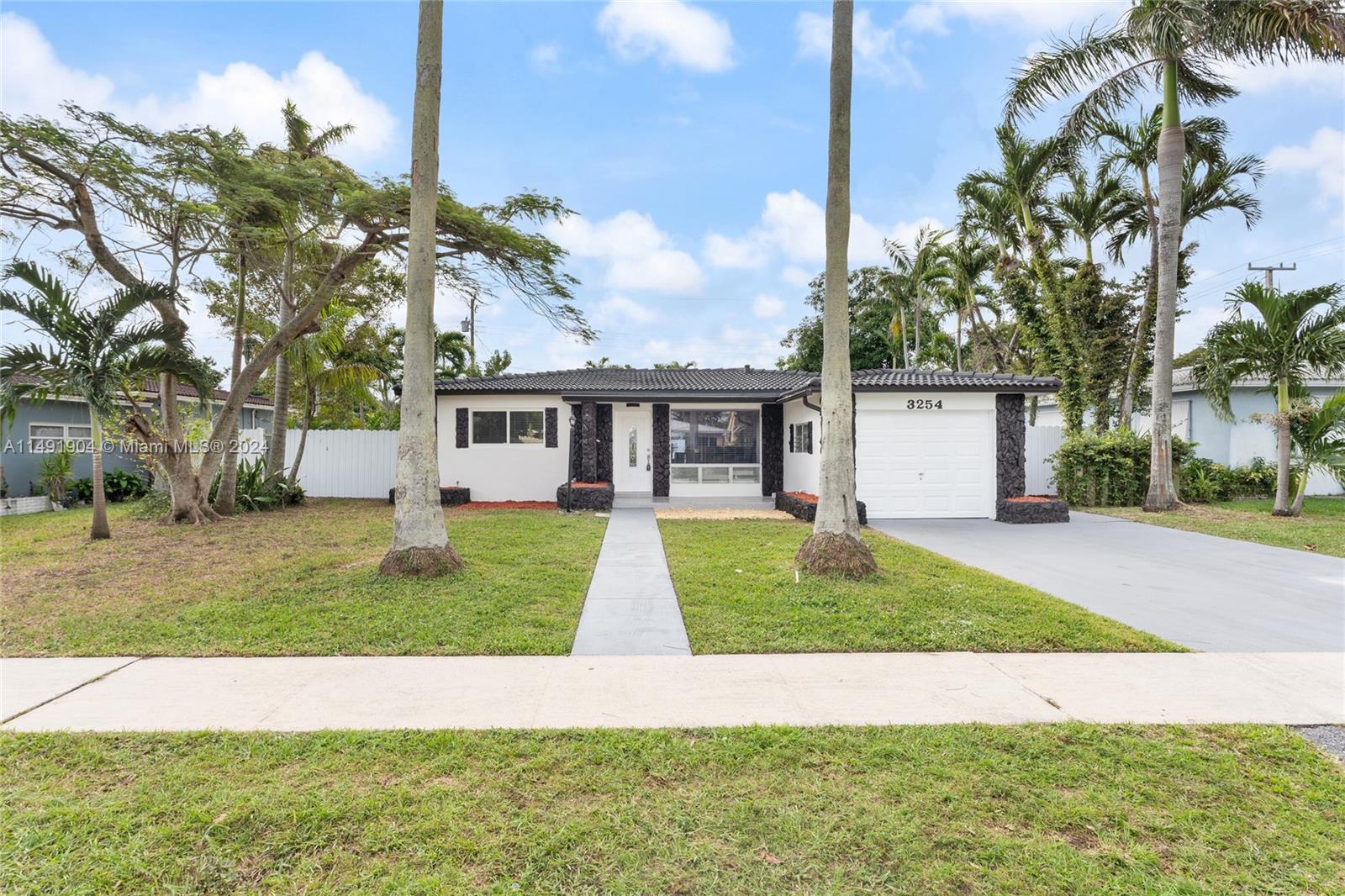 3254 Lincoln Street Hollywood, FL 33021 - Photo 5 of 27 a view of a yard in front of a house with a garden