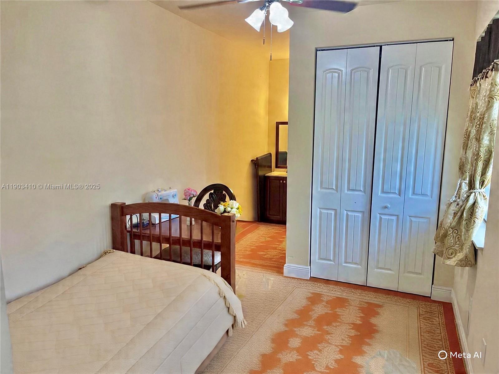 3301 Southwest 139th Avenue, Unit 3301 Miramar, FL 33027 - Photo 12 of 44 a bedroom with a bed and a chandelier