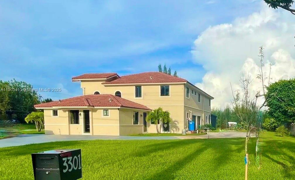 3301 Southwest 139th Avenue, Unit 3301 Miramar, FL 33027 - Photo 2 of 44 a front view of a house with a yard