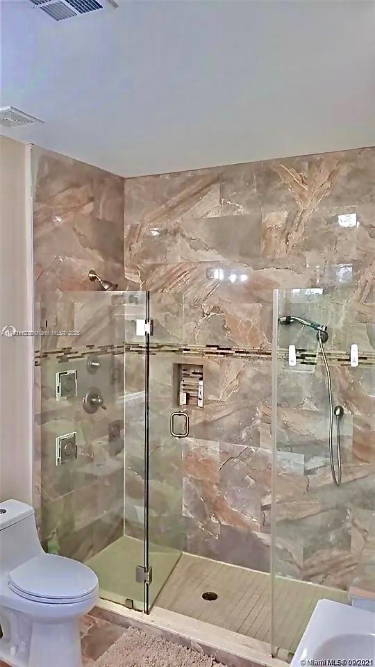 3301 Southwest 139th Avenue, Unit 3301 Miramar, FL 33027 - Photo 26 of 44 a bathroom with a shower a toilet and a sink