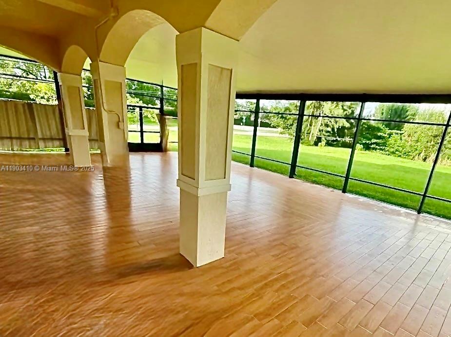 3301 Southwest 139th Avenue, Unit 3301 Miramar, FL 33027 - Photo 34 of 44 a view of empty room with wooden floor and windows