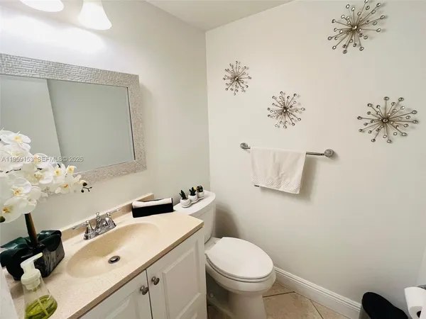 a bathroom with a sink mirror and toilet