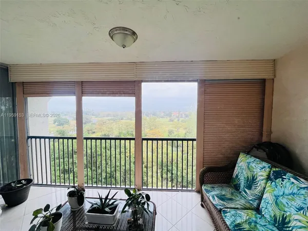 a balcony with furniture and a potted plant