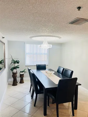a view of a dining room with a table and chairs