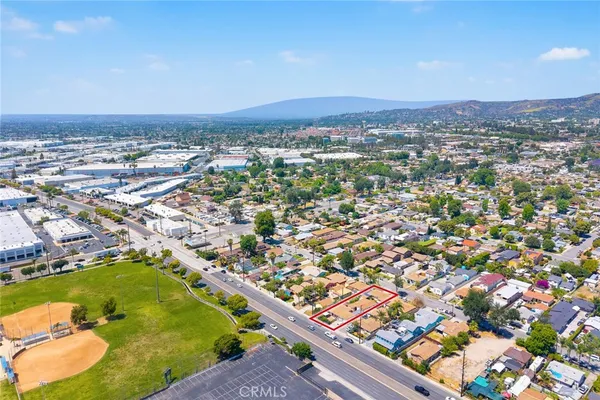 an aerial view of residential houses with city view