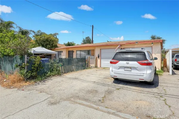 a view of a car parked in front of a house