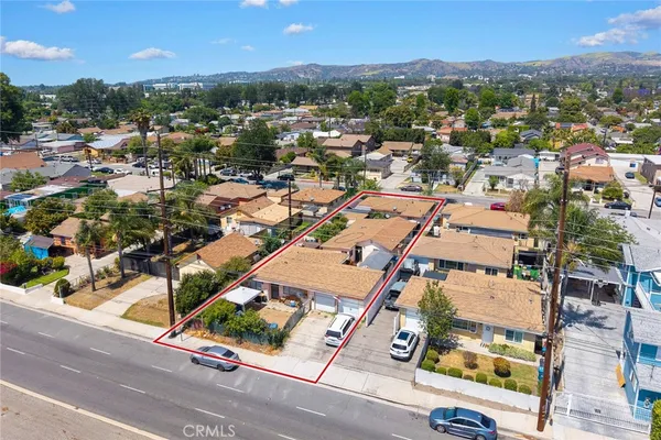 an aerial view of a building with parking
